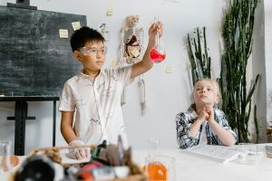 Two kids are busy conducting a science experiment together, showing teamwork and curiosity