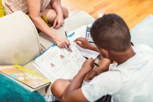 A boy studying with his tutor